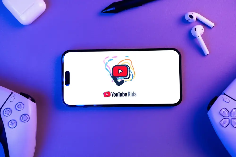 Smartphone displaying the YouTube Kids app on a desk representing children’s data privacy issues